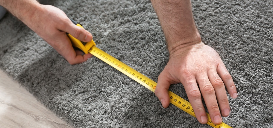 Person measuring for new carpet